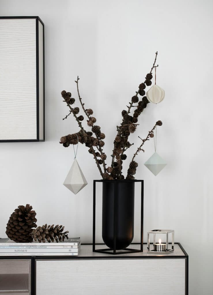 Holiday Decoration - ornaments and pine cones on living room stand